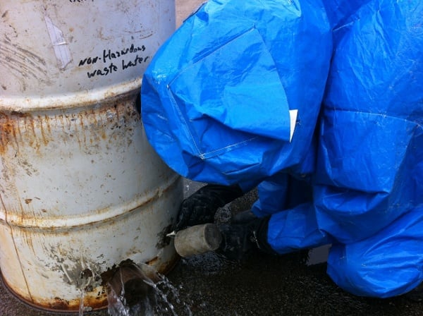 Student plugging a hole in barrel properly during hazmat training exercise